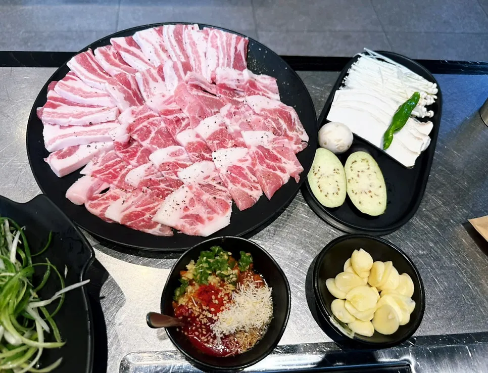 Four complimentary side dishes: steamed egg, spicy noodle salad, flat dumplings, assorted mushrooms