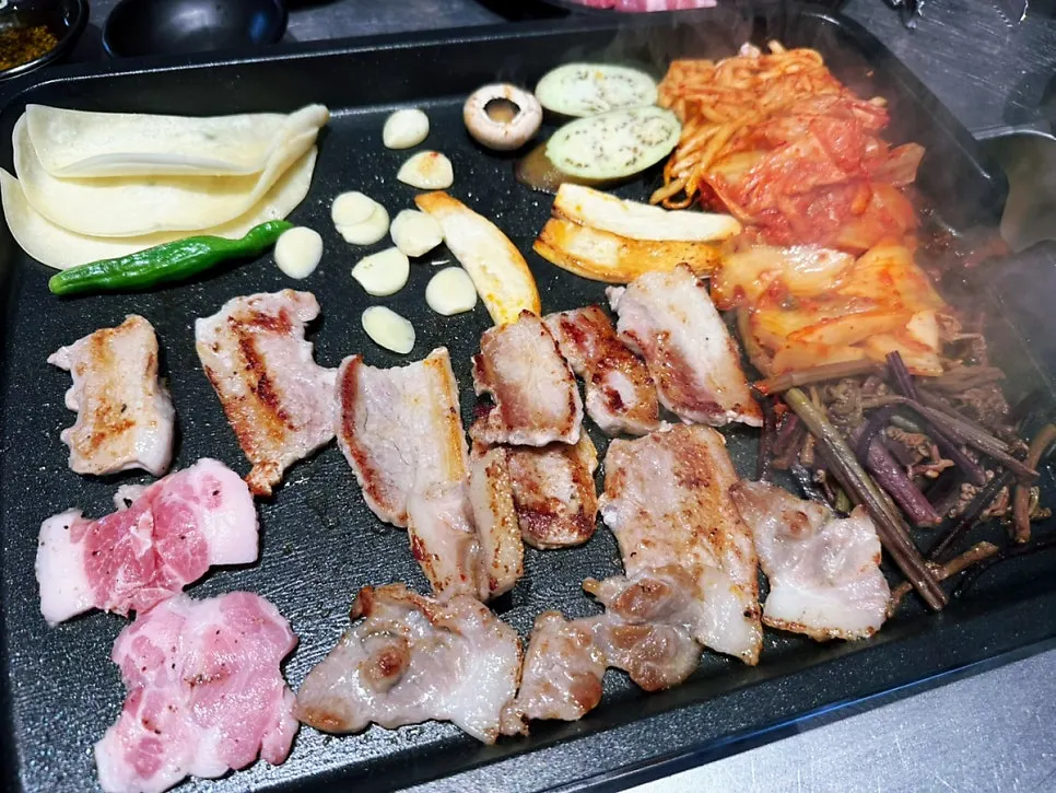 Pork belly grilling to a golden brown on the pan