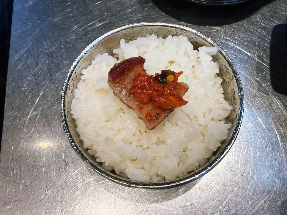 A piece of pork belly topped with ssamjang