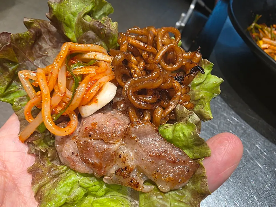 Eating jjagyechi noodles alongside the meat