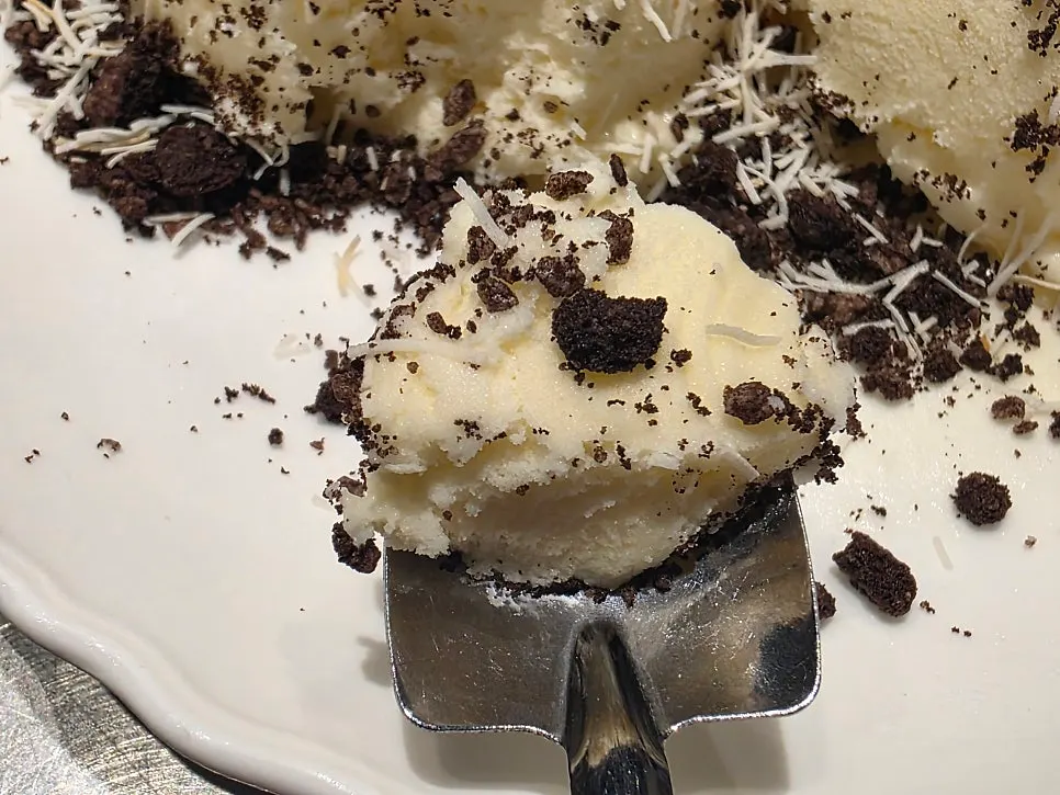 Taking a spoonful of the dessert