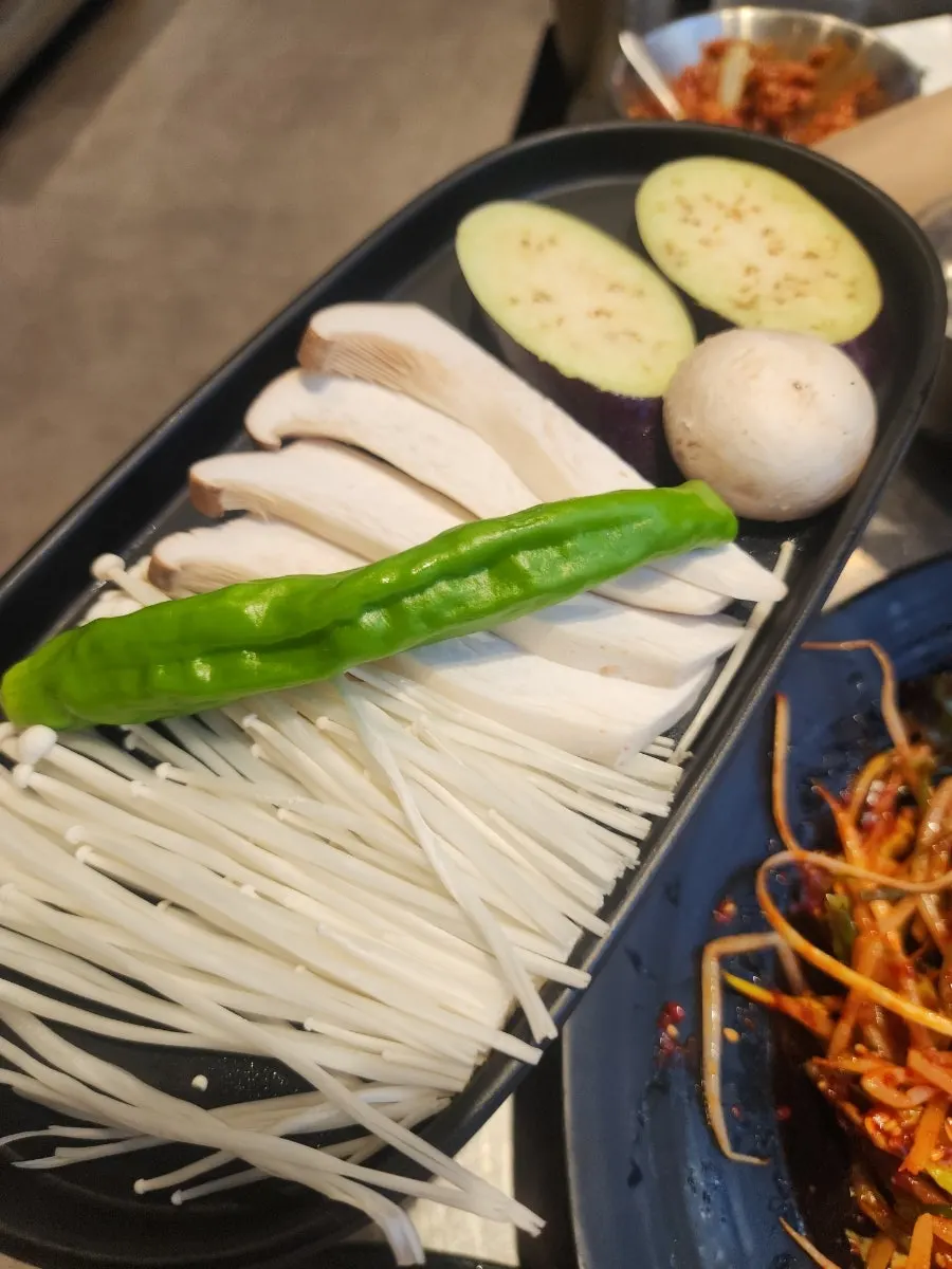 Free spread of Dubai chewy ssamjang, assorted mushrooms, and flat dumplings