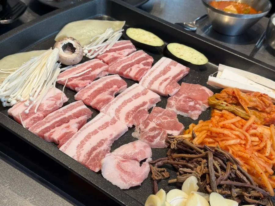 Samgyeopsal grilling to golden brown on the pan