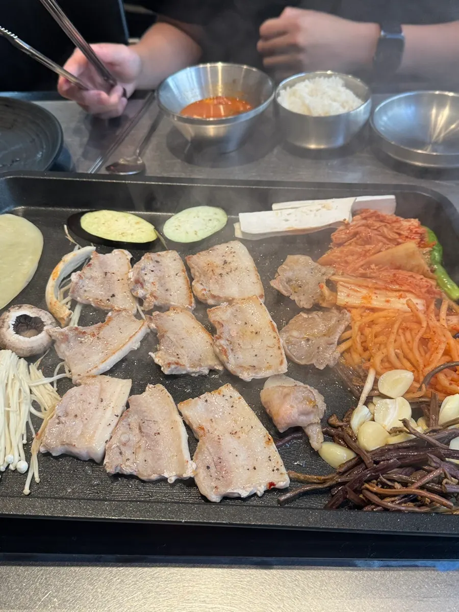 A piece of samgyeopsal dipped in chewy ssamjang
