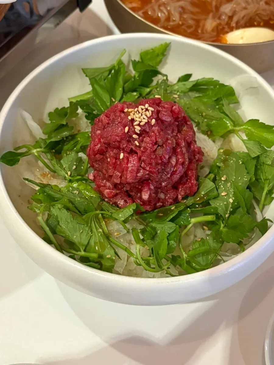 A full setting of soy-based hanwoo yukhoe bibimbap