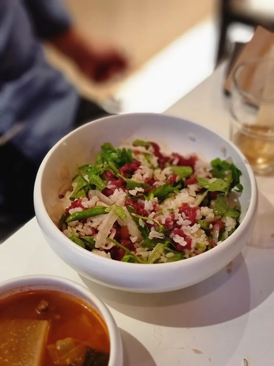 Yukhoe bibimbap topped with soy sauce-based raw beef