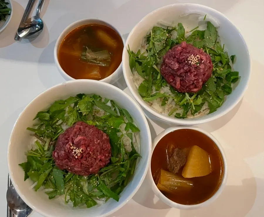 Table at Taegyeongok with yukhoe bibimbap and dumplings