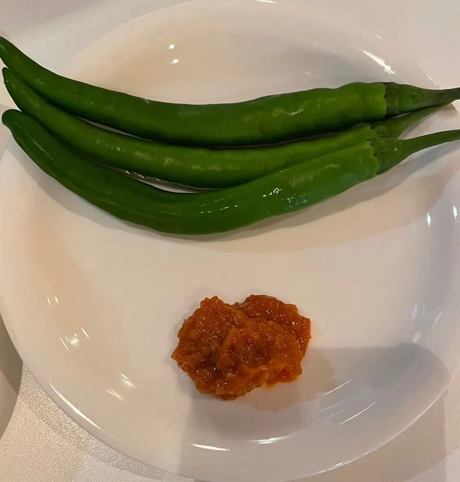 Plate of diced radish kimchi and peppers at Taegyeongok