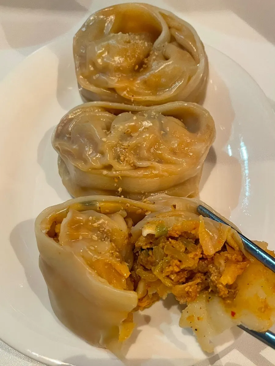 Taegyeongok dumplings with thin wrappers showing the filling