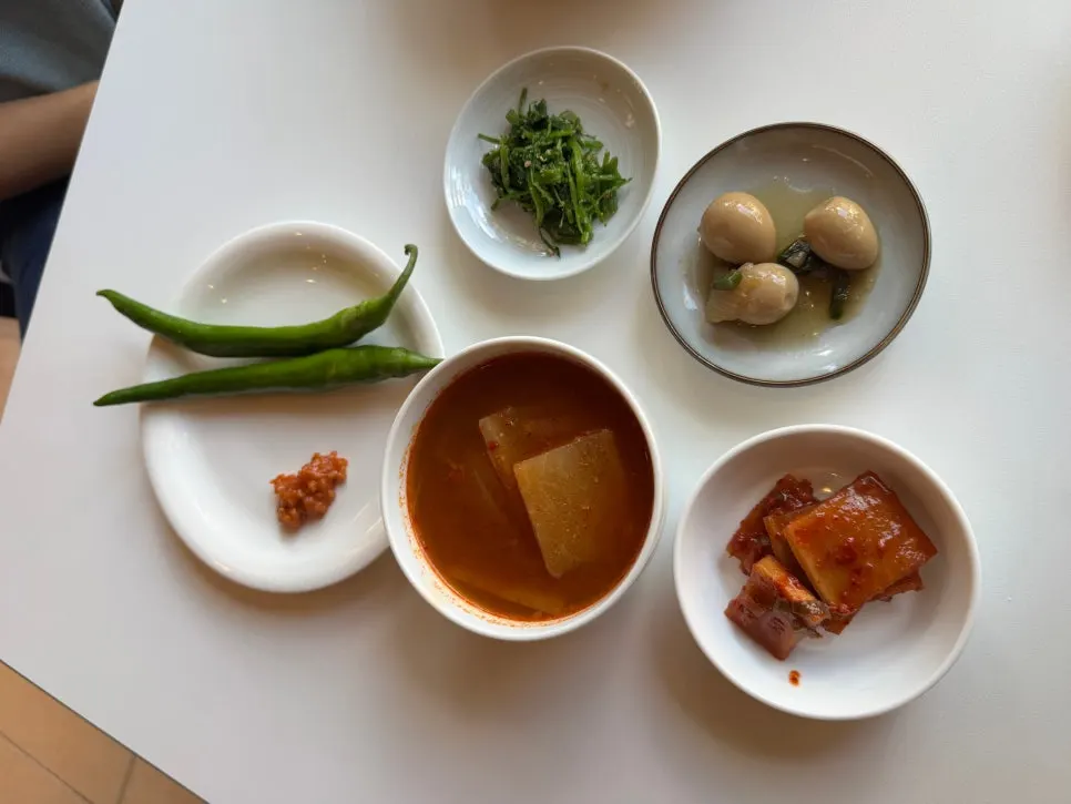 Taegyeongok side dishes including seokbakji and soy-braised quail eggs
