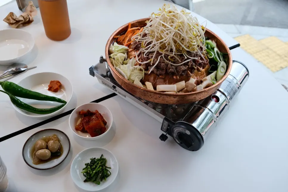 Side dishes at Taegyeongok including pickled quail eggs and nabak kimchi