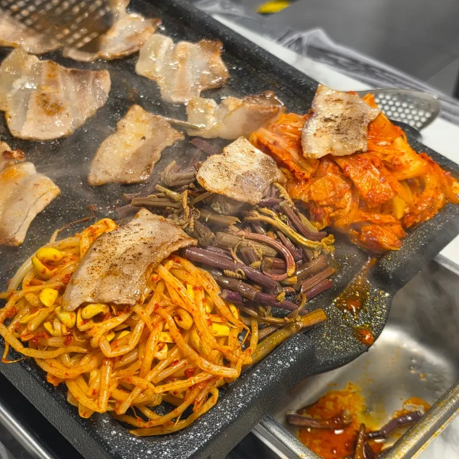 Grilled pork belly served on top of vegetables