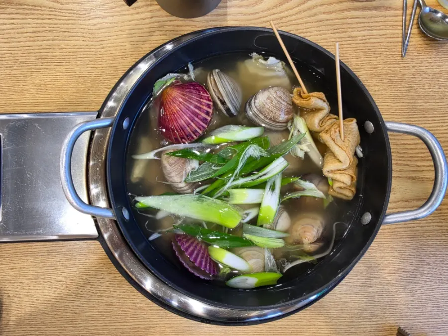 Clams fished out of the simmering soup