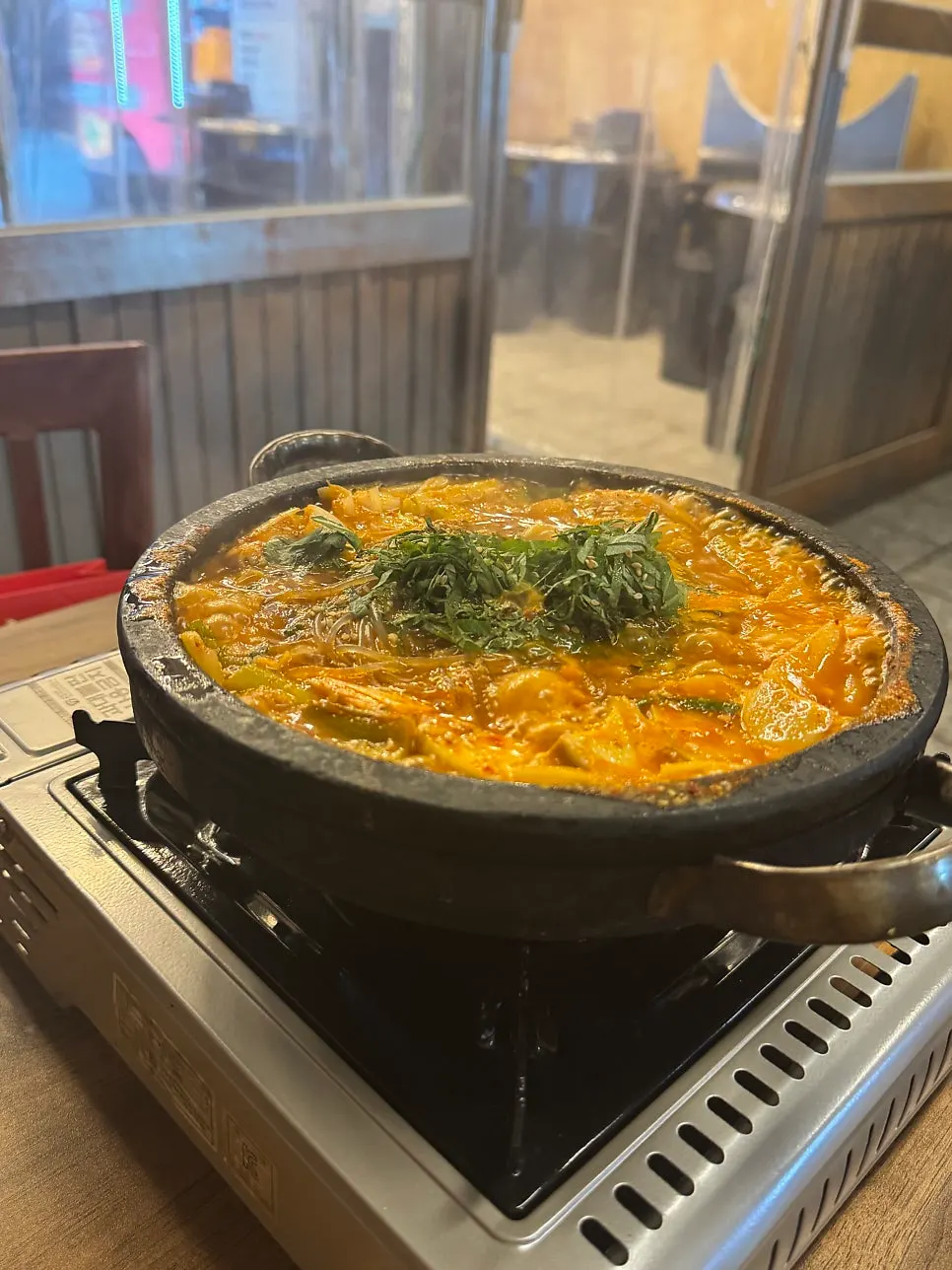 Beef gopchang hot pot bubbling in a stone pot