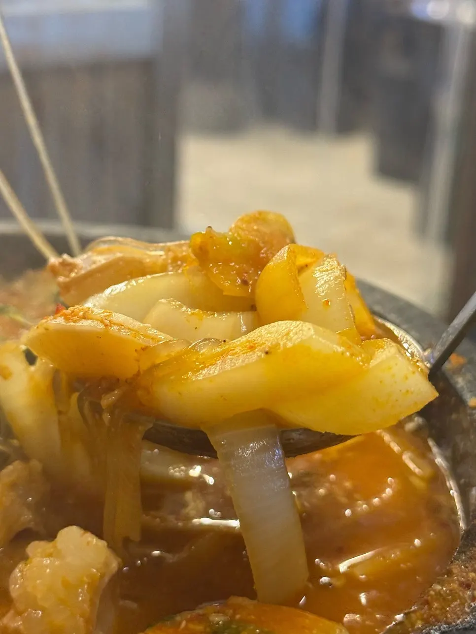 Gopchang hot pot topped with mushrooms and sesame leaves