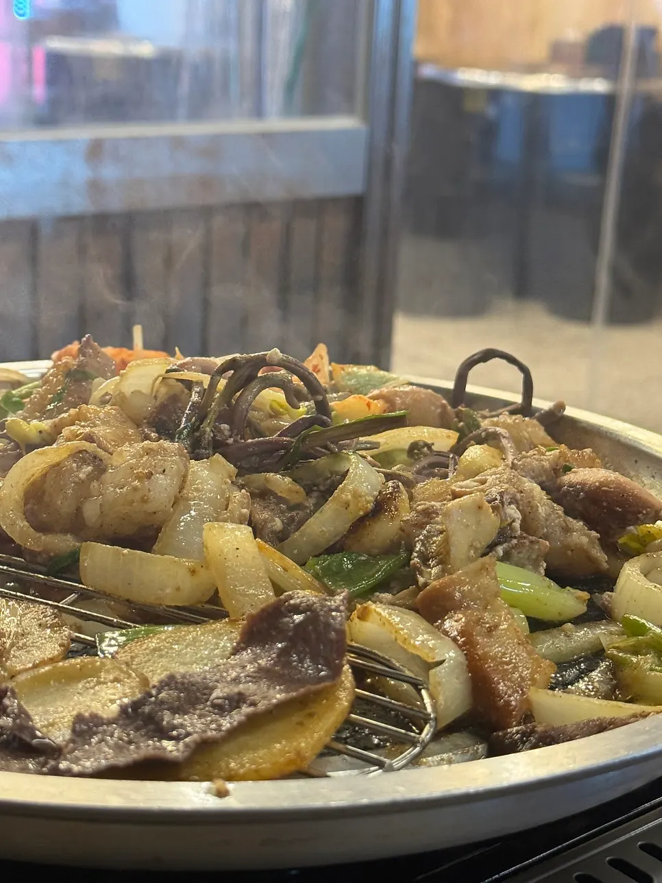 Table of assorted gopchang and side dishes