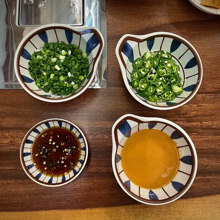A plate of tangy seasoned scallion salad