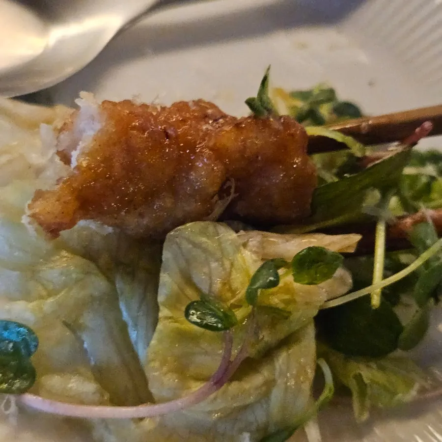 A plate combining pad thai and salad