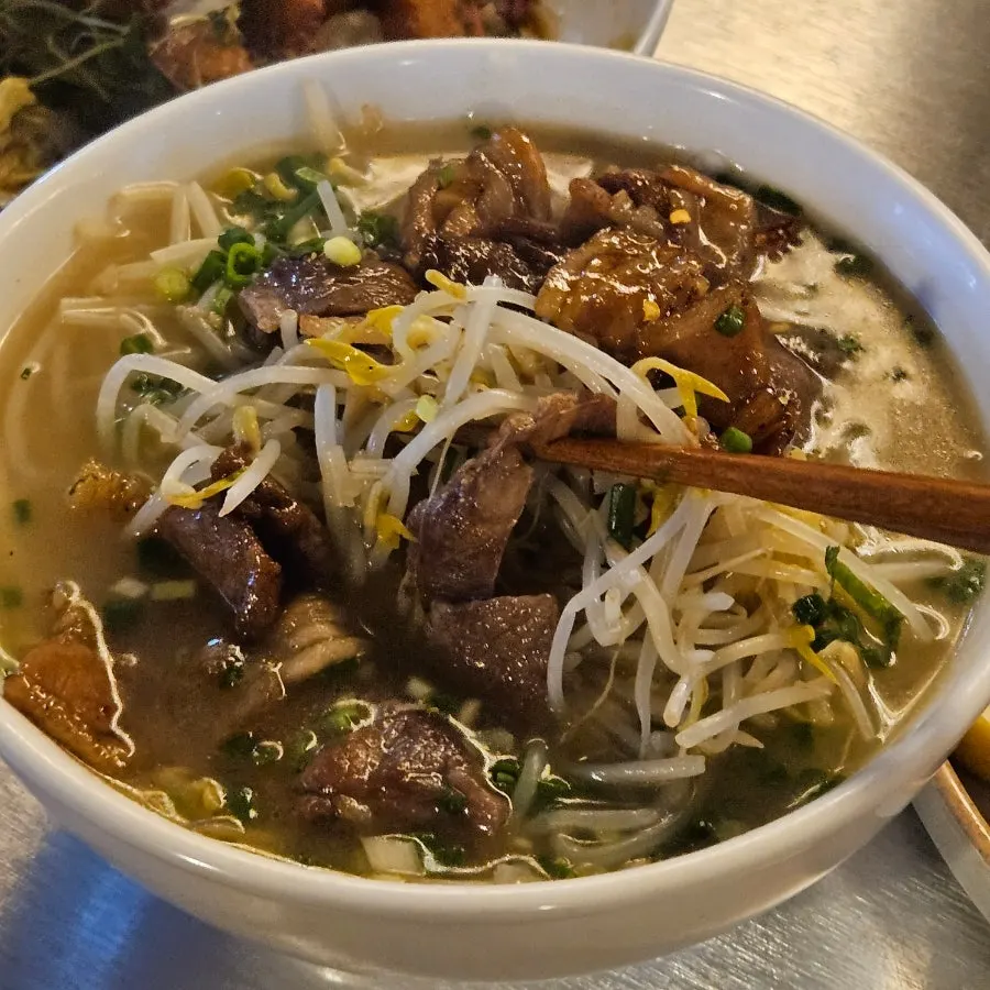 Rich broth and bean sprouts on top of the bulgogi rice noodle soup