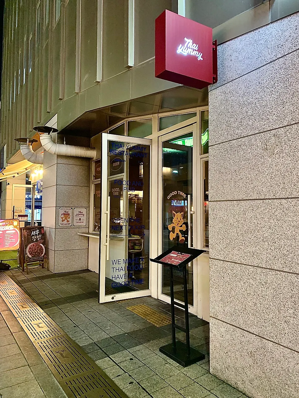 Thai Yami's exterior with the lit-up sign visible