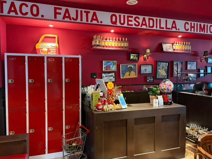 Wide tables and sofa seating inside Taqueros Magok Main Branch