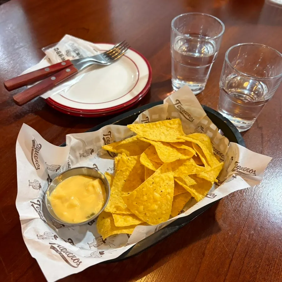Complimentary nachos and nacho sauce
