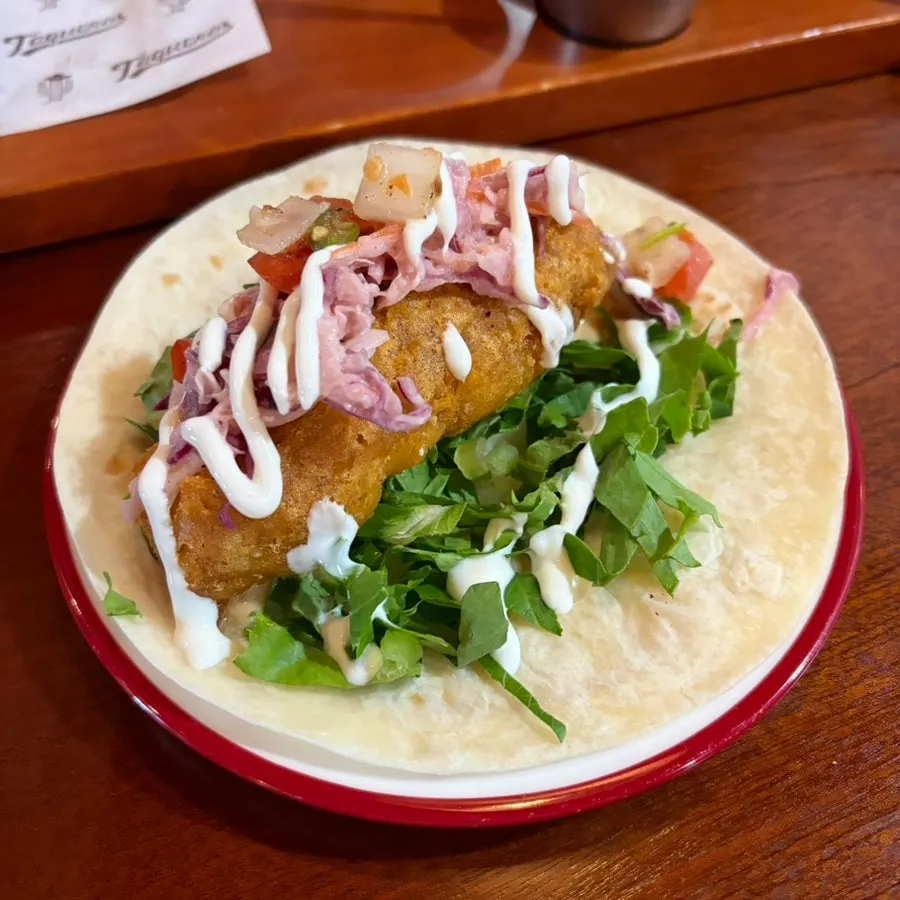 Close-up of a Taqueros taco topped with sauce