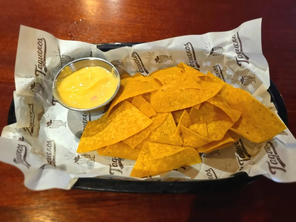 Complimentary nachos and cheese sauce