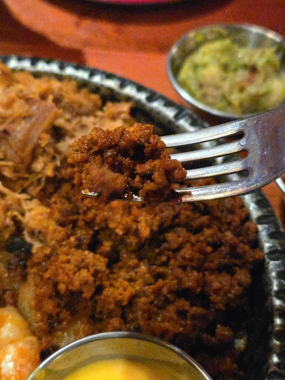 Loading meat and shrimp onto a tortilla