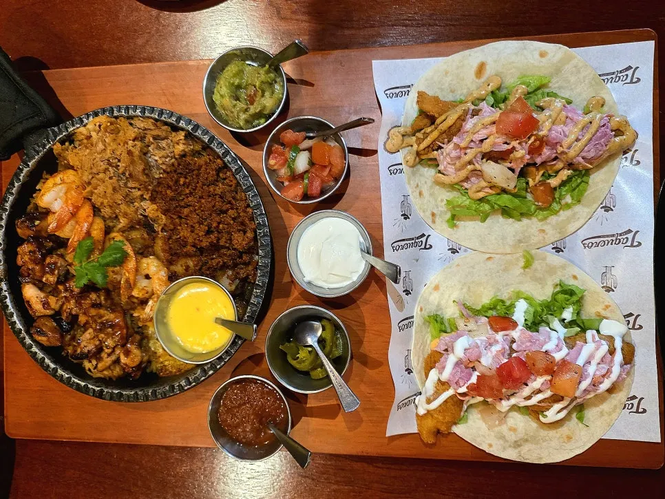 Two tacos piled high with toppings