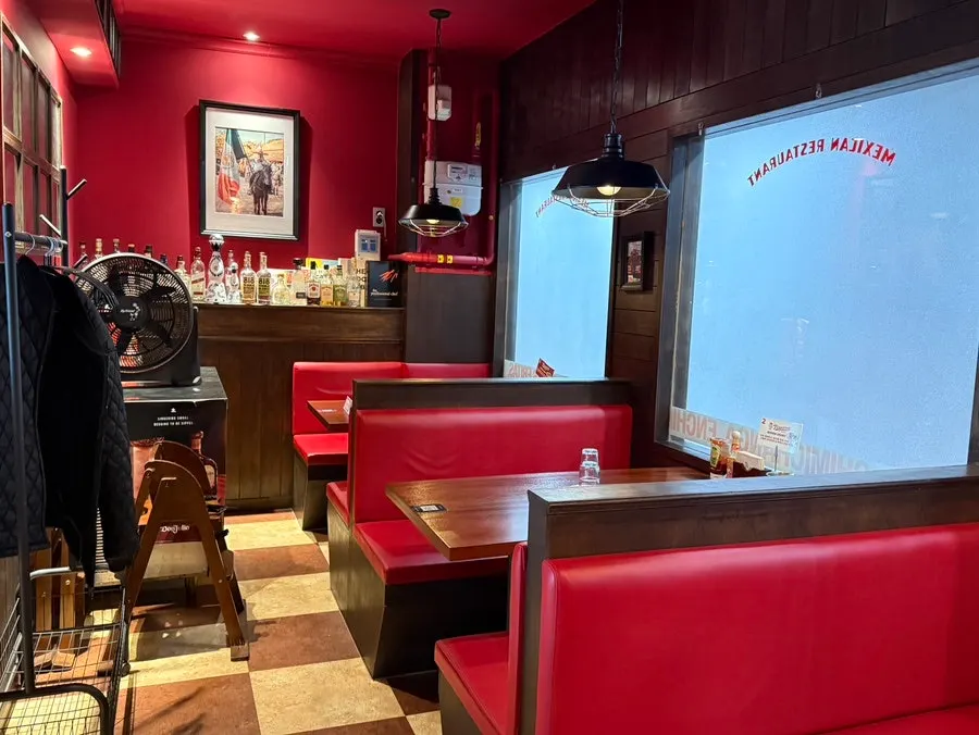 Interior of Taqueros with Mexican-style props and lighting
