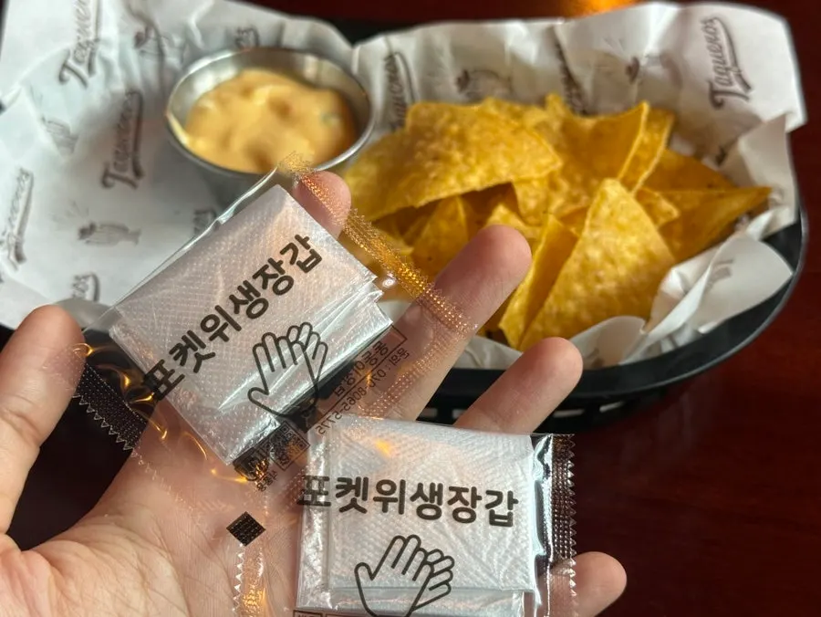 Disposable gloves and nachos set on the table