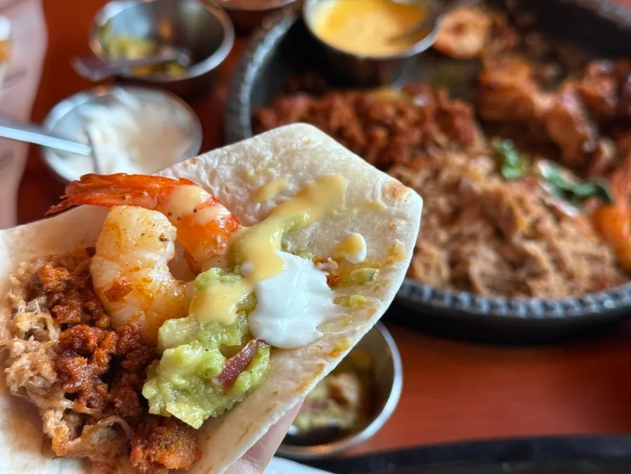 Skillet of fajita with beef, pork and shrimp