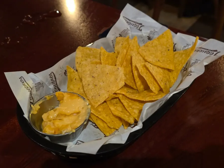 House nachos with cheese sauce served first