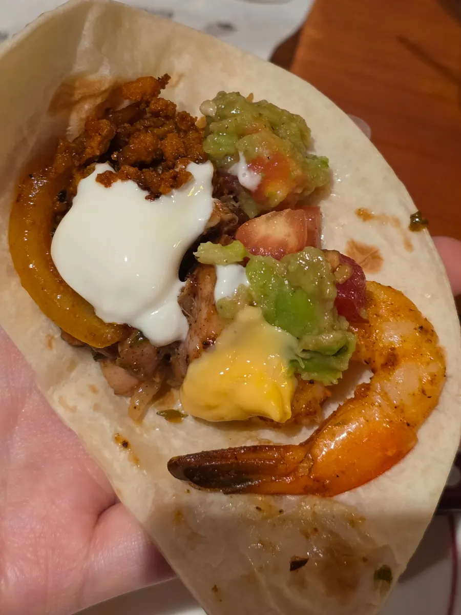 Tortilla wrapped with all the meats and sauces