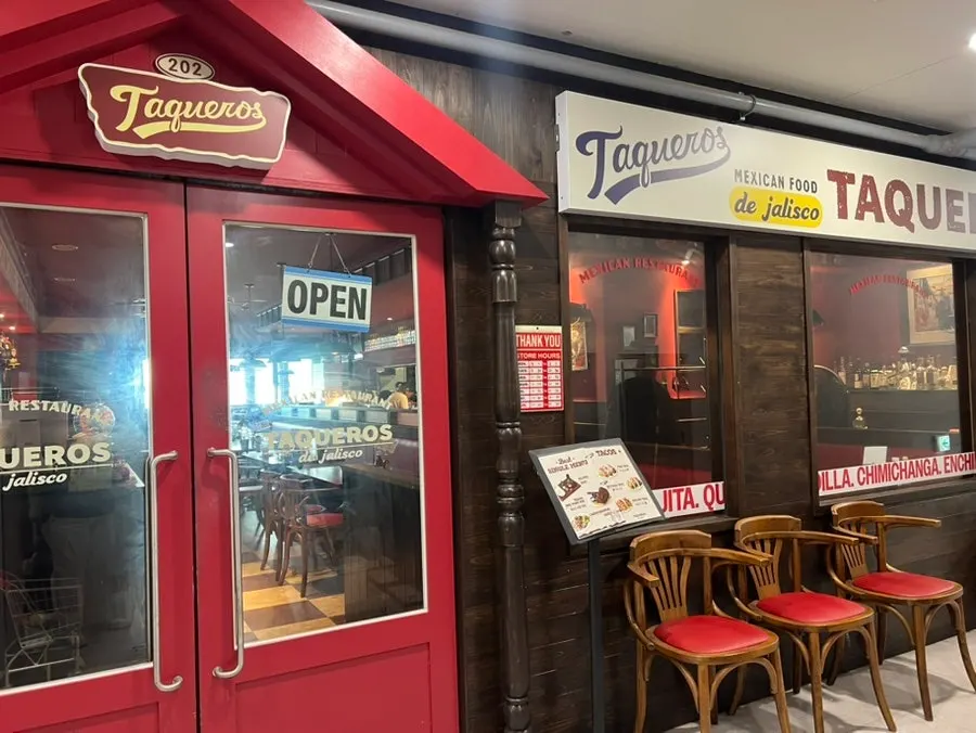 Taqueros Magok's red door and wood-tone exterior