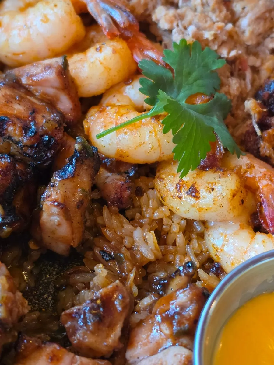 Fried rice layered underneath the grilled chicken