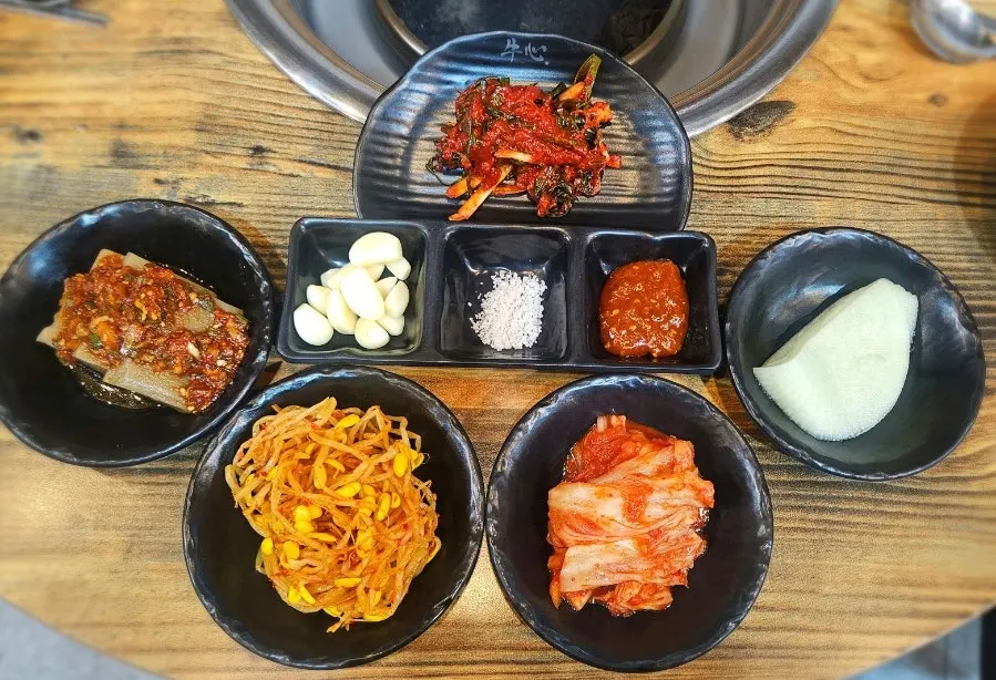 Table spread of basic side dishes at Tamra Factory
