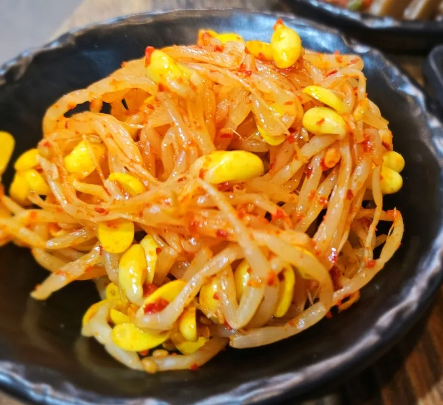 Plates of baechu kimchi and pa kimchi