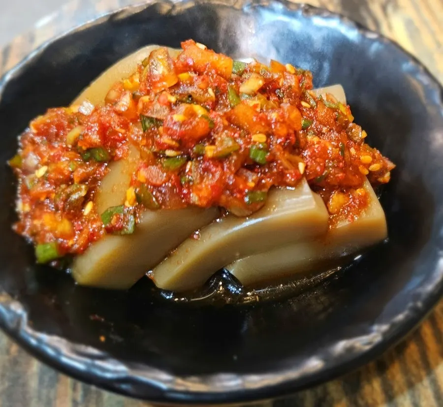 Pickled radish and other side dishes served with the meat