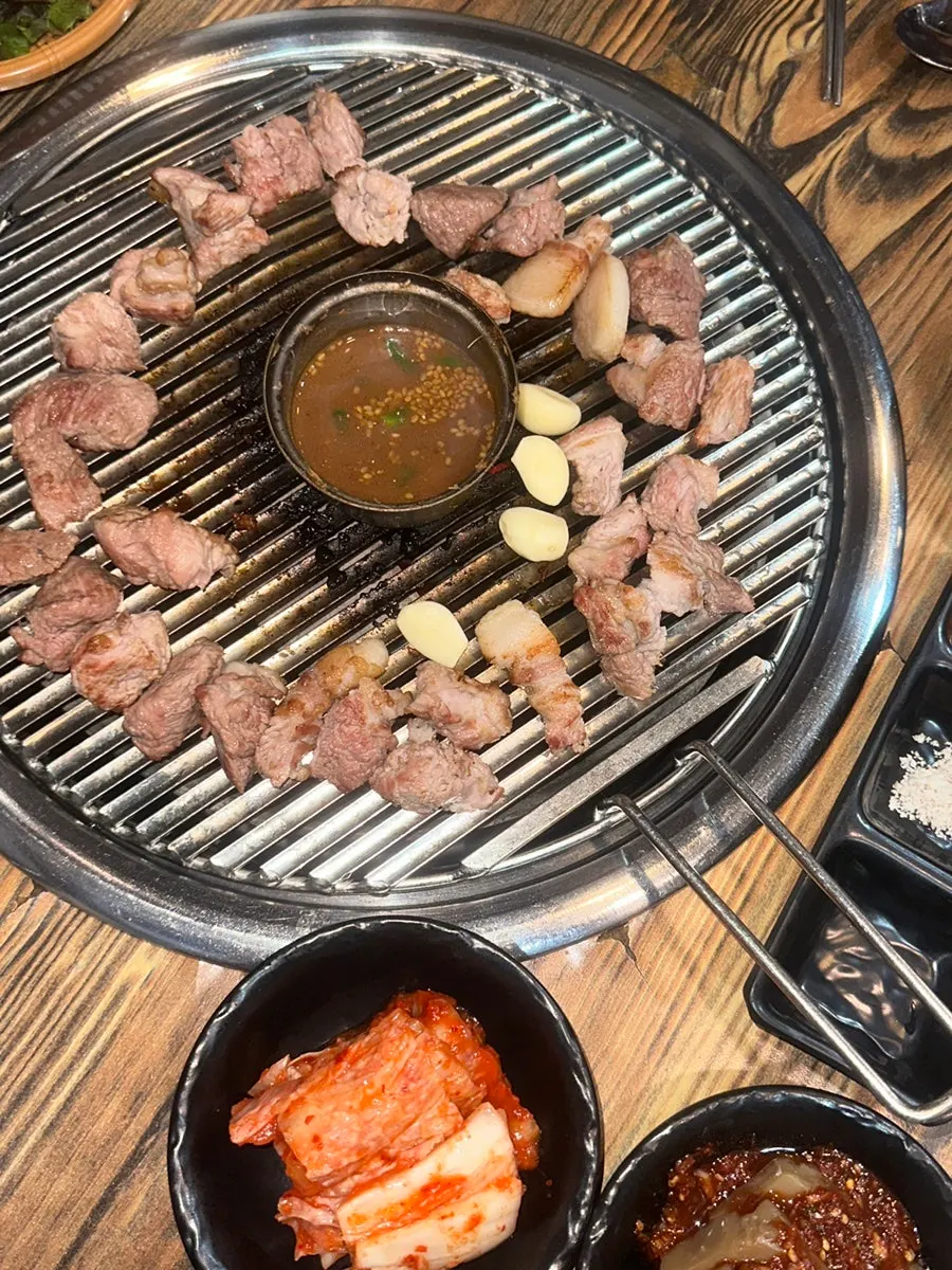 Staff grilling meat at Tamra Factory Magok Direct Store
