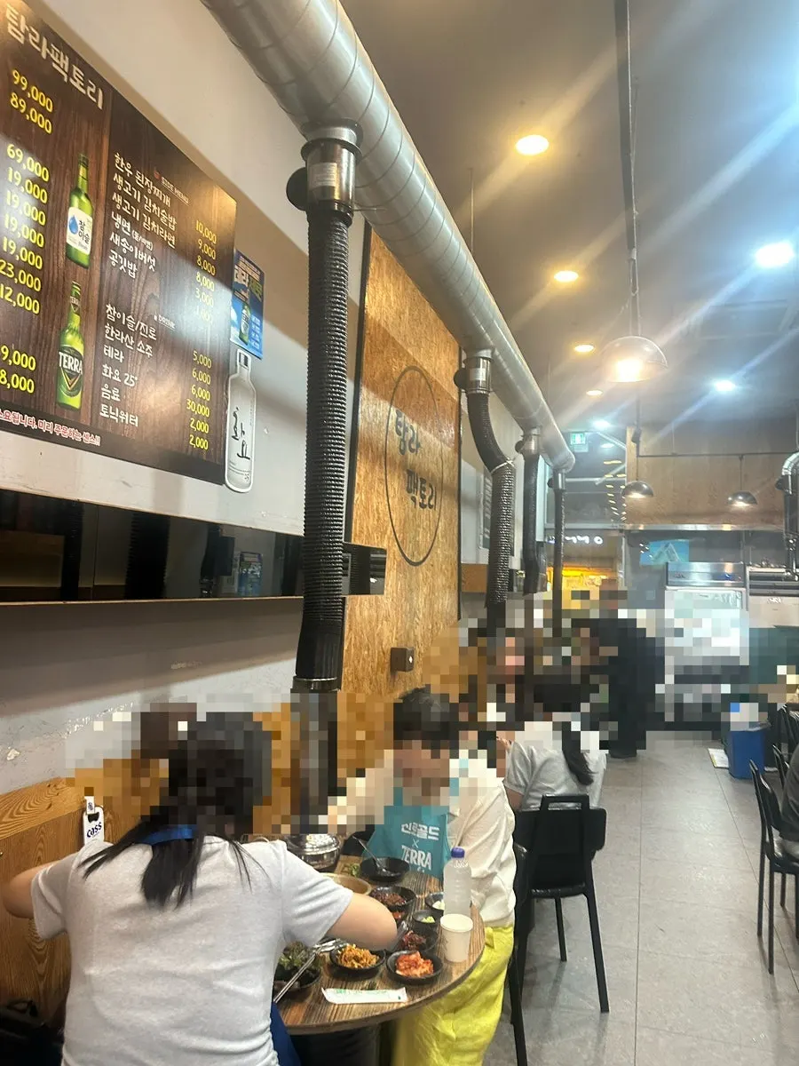 Long dining hall stretching toward the back of Tamra Factory Magok Direct Store