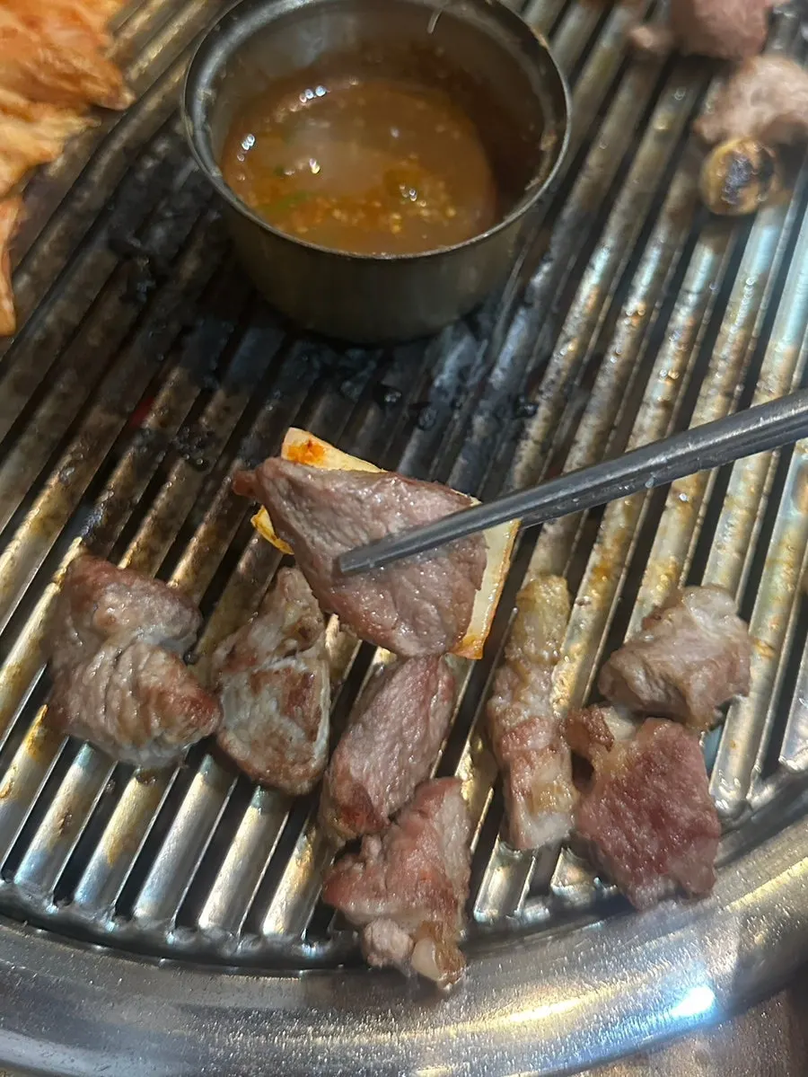Thick pork neck finishing on the tabletop grill