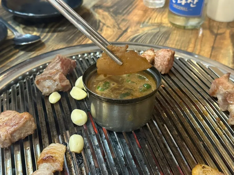 Melchet simmering in the middle of the grill with pork neck