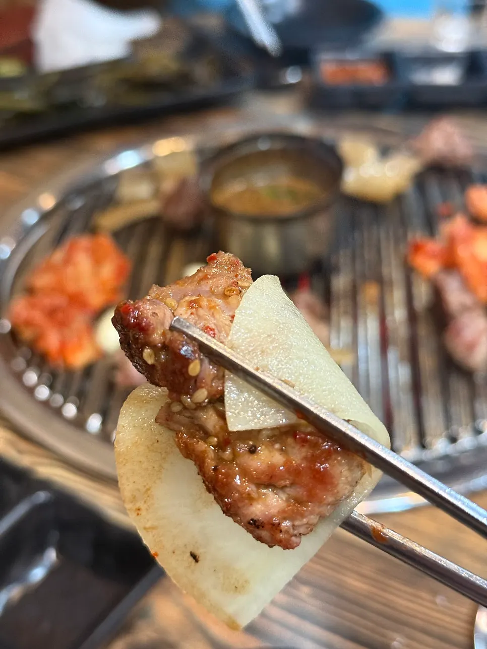 Pork neck and pork skin grilling together on the grill plate