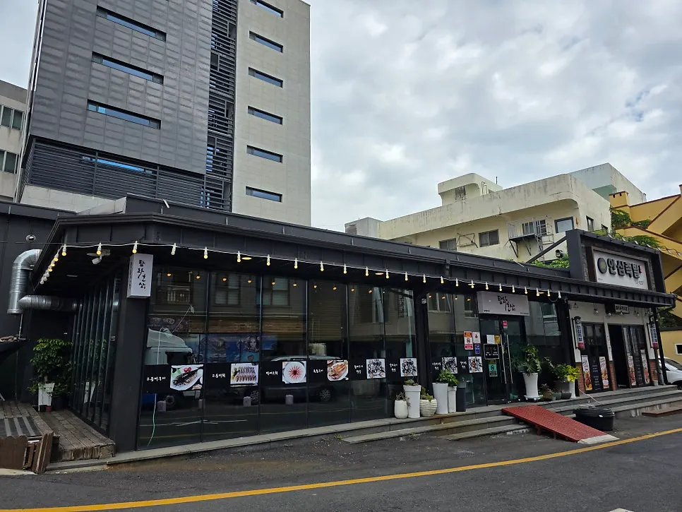 Exterior of Tamra Hansang nestled between taller buildings