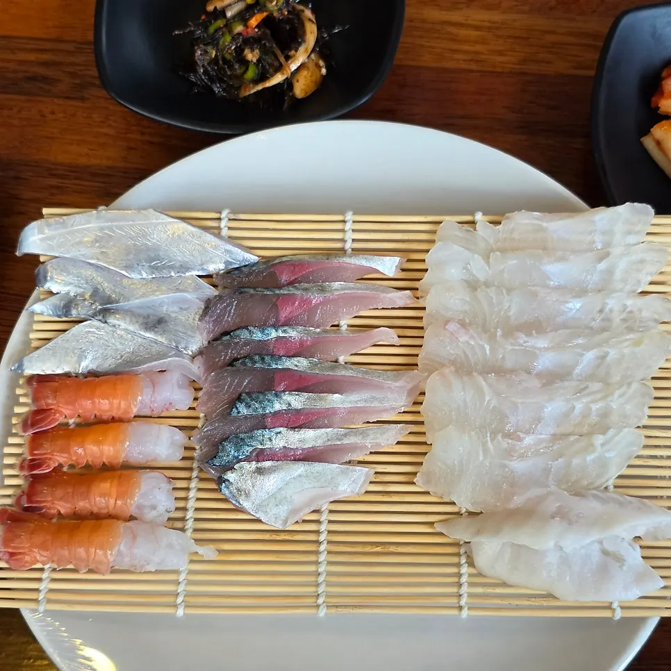 Assorted fresh sashimi platter with sweet shrimp, cutlassfish, mackerel, and flounder