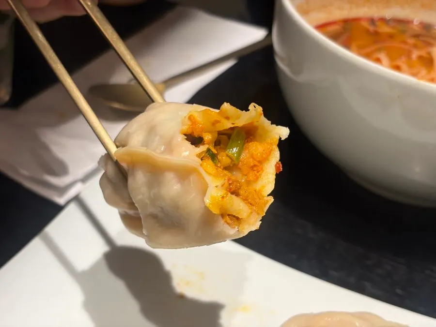 A kimchi mandu cut in half at Tanbaek