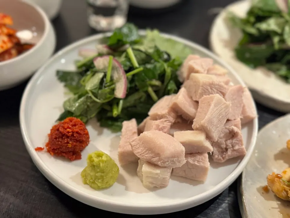 Full table spread with warm pork jowl at Tanbaek
