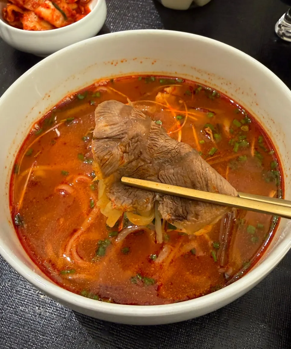 Close-up of kalguksu topped with chadolbagi brisket
